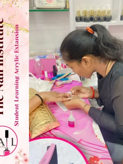 A student is deep in concentration while learning to apply acrylic extensions, a core part of our nail technician course.