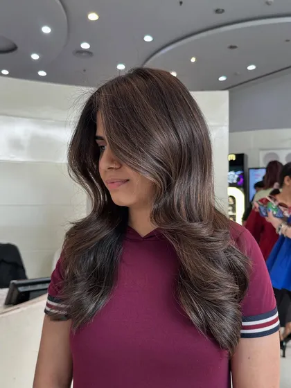 A final look at this voluminous cappuccino brown style. The color is deep and glossy, and the styling really shows off the expert cut and color.