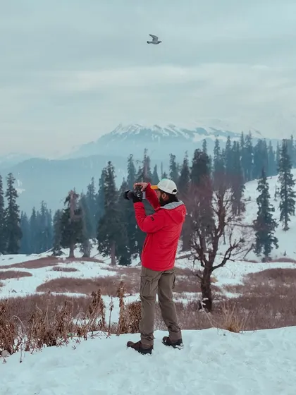 This is me in my element, finding the perfect shot in the snow-covered mountains of Kashmir. I'm always ready for an adventure, camera in hand, to capture the beauty of the world.