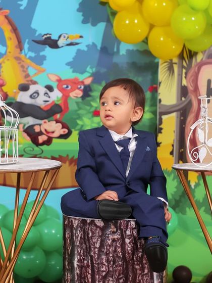 A thrilling 'PJ Masks' themed birthday party, with character cutouts, a cityscape backdrop, and blue and green balloons, ready for a night of adventure.