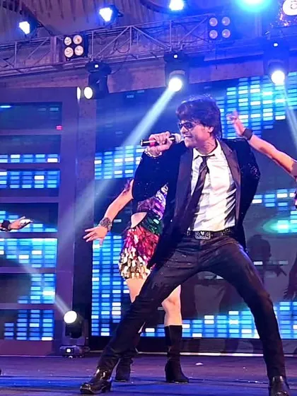 A close-up shot of me singing with my dancers in the background. The focus is always on delivering a powerful vocal performance amidst the choreography.