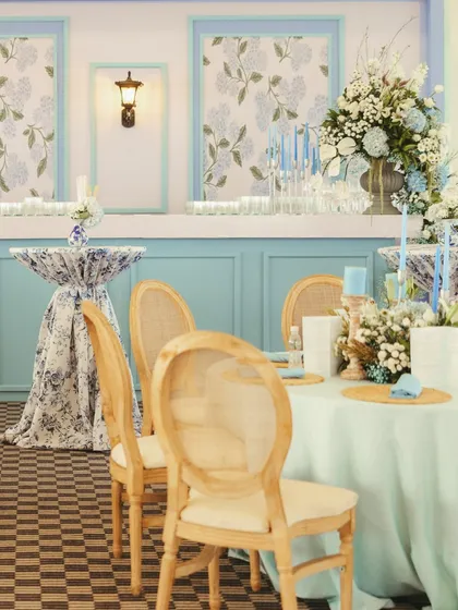 A detailed shot of the blue and white decor, showing the elegant paneling, floral-print fabrics, and classic furniture that created a sophisticated, Western-inspired atmosphere.