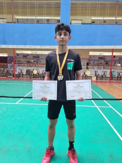 Zehn Masani showcasing his two gold medals for winning both the Boys Singles U17 and Boys Doubles U17 events. A remarkable double victory.