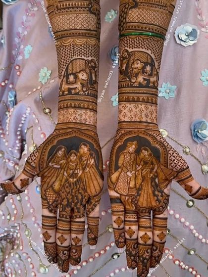 A detailed design featuring family portraits on both palms, surrounded by intricate patterns and elephant motifs.