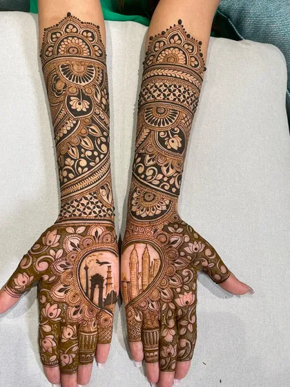 Your mehandi can be a canvas for what's special to you. For this bride, we included landmarks from her love story, featuring the India Gate and the Petronas Towers, blending personal memories with traditional bridal art.