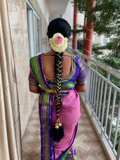 A beautiful example of a traditional bridal braid using a hair extension for added length and volume, finished with a neat jasmine veni.