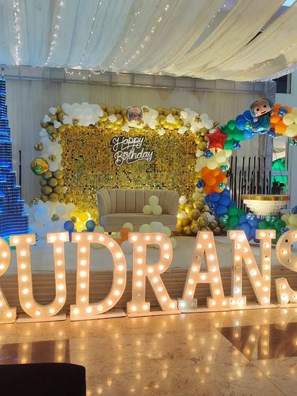 A grand Cocomelon stage backdrop with a flower wall, balloon arch, and a prop of the Burj Khalifa, showing my ability to incorporate unique elements.