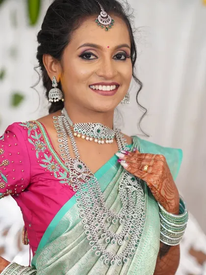 A happy bride at her reception, wearing a full American Diamond set. The sparkle of AD jewellery is perfect for evening celebrations.