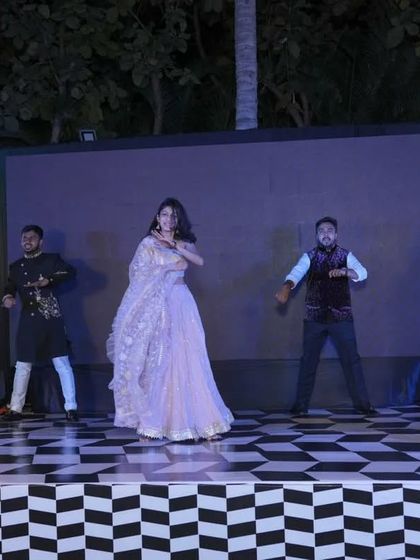A beautiful shot of the bride performing with her backup dancers. The lighting and stage setup make this a truly professional-looking performance.