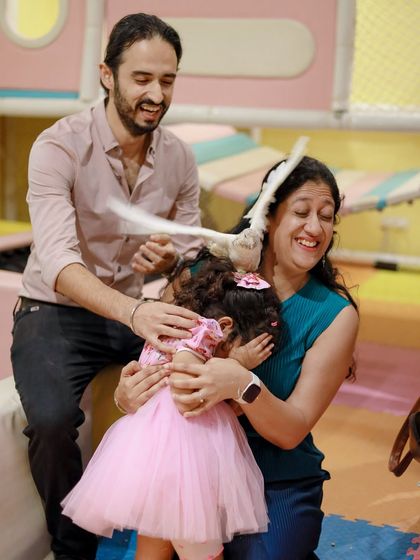 A moment of surprise and laughter as a dove from the magic show interacts with the family. These unscripted, happy moments are the best.