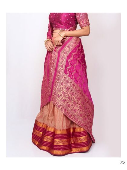 This two-tone silk lehenga in beige and magenta offers a beautiful contrast. The rich banarasi dupatta adds a layer of traditional elegance.
