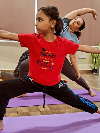 Yoga is a powerful tool for children. In my kids' classes, we work on asanas like Virabhadrasana II (Warrior II Pose) to build real strength, improve concentration for school, and develop a calm mind. We make it fun so they build habits for life.