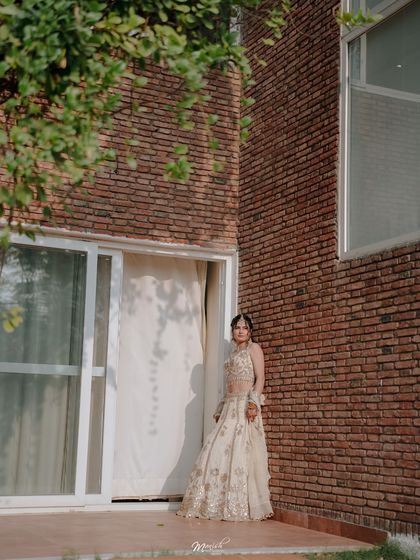 A quiet, artistic portrait of the bride-to-be, waiting in a moment of reflection before her engagement ceremony.