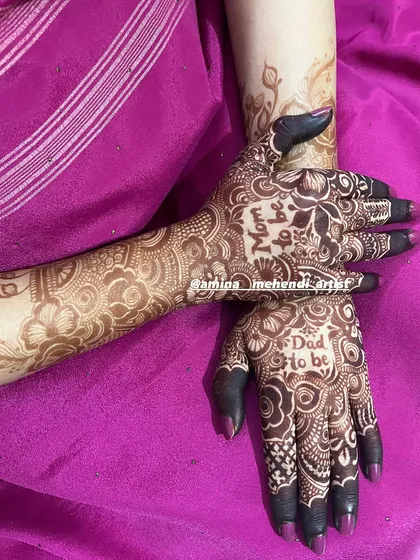 A special design for the parents-to-be. This mehendi features "Mom to be" on one hand and "Dad to be" on the other, woven into a lovely floral pattern.