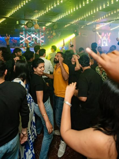 A packed dance floor at Nolimmits during a Bollywood Bhangra night. The energy is contagious when the whole club is jumping.