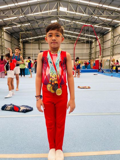 A close-up of our young champion, Saurvik, with his impressive collection of medals from the National Level Infinity Leap competition, including gold in pommel horse.