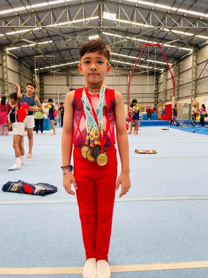 Standing tall and proud. This young champion showcases the impressive collection of medals earned through his dedication.