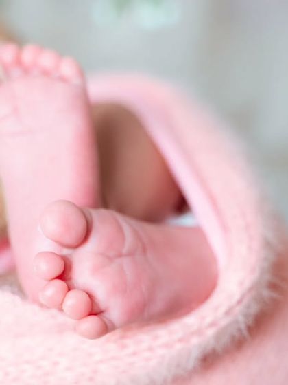A detailed shot focusing on the tiny, perfect toes of a newborn. These close-ups are a beautiful addition to any newborn photo gallery.