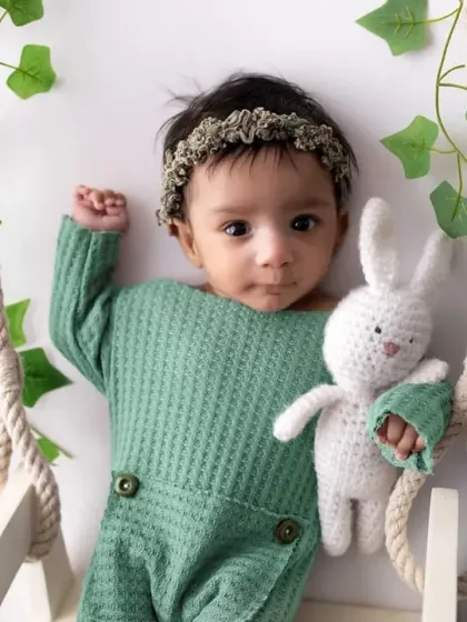 Swinging into the world with the cutest expression. This setup with a miniature swing, soft greenery, and a cuddly bunny friend is one of my favorites for capturing awake and curious newborns.