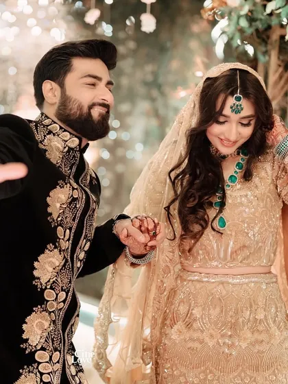 A playful, happy moment between the couple, capturing their chemistry and their beautifully coordinated reception looks.