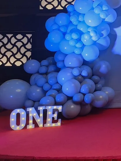 A light-up 'ONE' sign, perfect for a first birthday, seen here at the hot air balloon themed party.