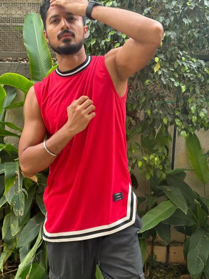 A dynamic pose that shows off the fit of the athletic top and my physique.