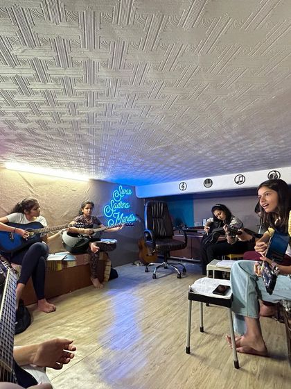 Our guitar class in session, with students focused on their practice. The atmosphere is relaxed and encouraging, perfect for creative learning.