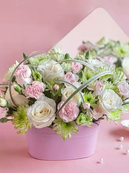 A bouquet says what words often can't. This modern arrangement in a pink box is perfect for a first date or any romantic occasion.