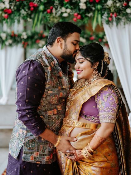 An intimate portrait of the expecting couple. Their coordinated outfits, in shades of lavender and yellow, were designed to celebrate this joyous new chapter.