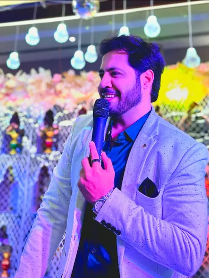 A happy, candid shot with the mic in hand. This is me, genuinely enjoying the celebration with you.