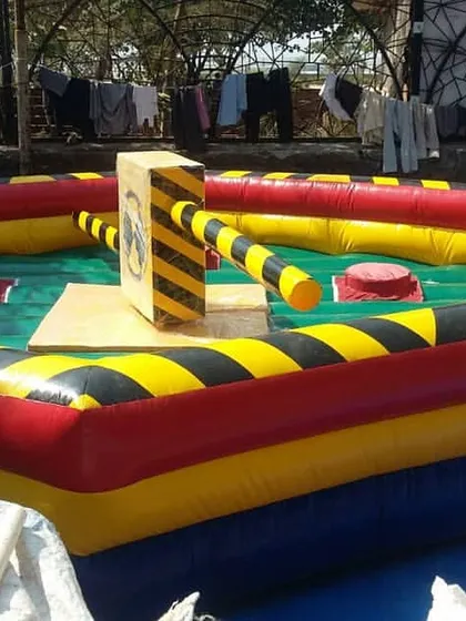 This is our Eliminator inflatable game. It's a competitive obstacle course where players have to jump and duck rotating arms, perfect for bringing high energy to corporate offsites or large parties.