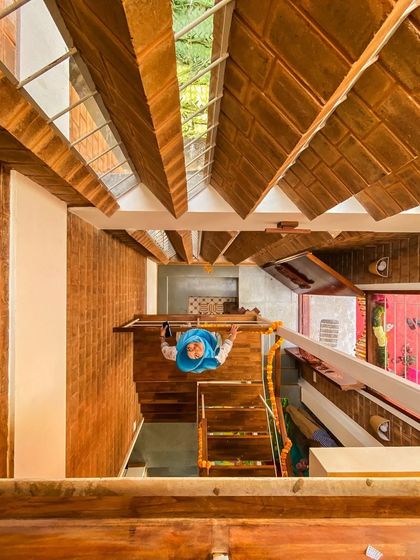 A unique overhead shot of the Divyadarshan home's staircase. This perspective reveals the complex interplay of levels and materials we designed to maximize space on a very small site.