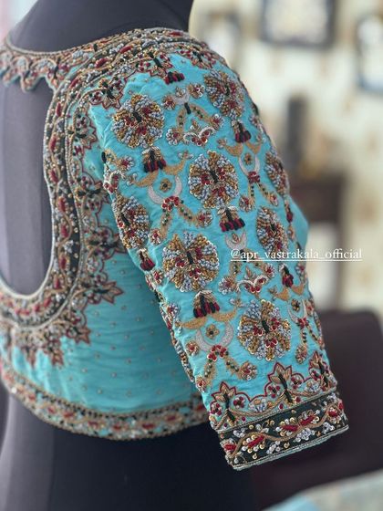 A side view of the light blue blouse on a mannequin, showing the sleeve detail.