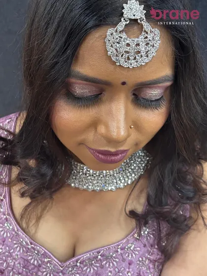 A close-up of the glittery lavender eye makeup, a popular choice for evening wedding events.