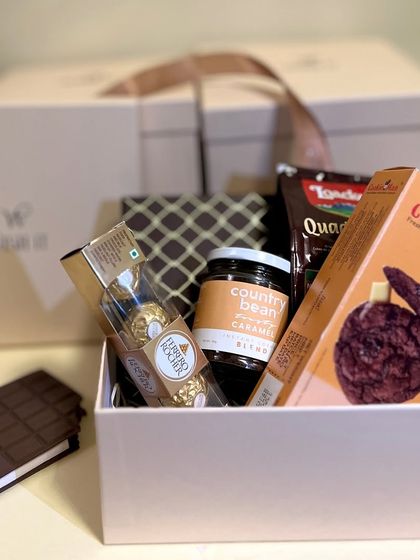 Our "Choco Fix" hamper is the perfect solution for any chocolate craving. It features treats from Cookie Man, Ferrero Rocher, and Country Bean coffee for the ultimate indulgence.