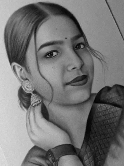A close-up of a finished portrait, highlighting the jhumka earring and soft expression.