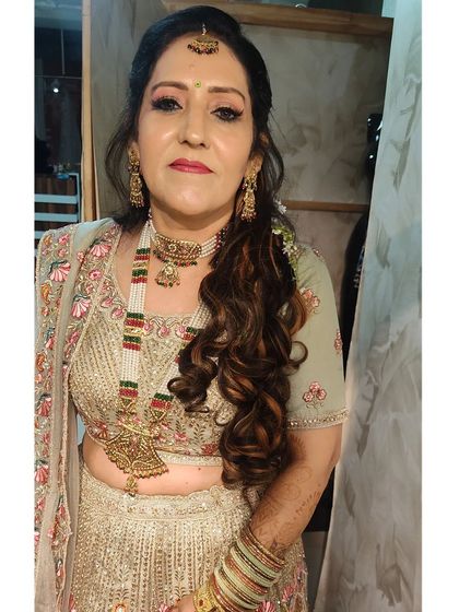 A close-up of a client in a pastel green lehenga, showing the makeup and heavy necklace she paired with it.