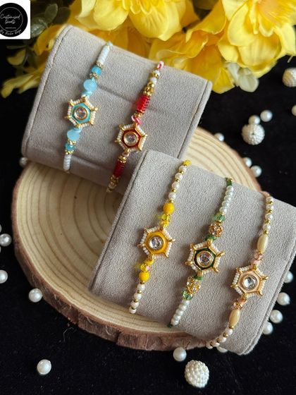 Modern star-shaped rakhis with a central stone. Available in multiple colors like red, blue, and yellow, these are perfect for a brother with a contemporary style.
