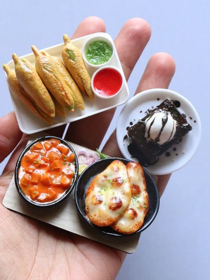 A handful of my most popular miniatures, including mirchi bajji, naan with paneer, and a brownie with ice cream.