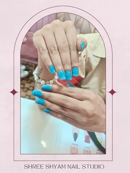 A styled shot of these vibrant blue glitter nails, perfect for when you want a pop of color.
