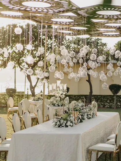 We can't get over this dreamy and mystical white setup. The hanging glass baubles and all-white floral arrangements create an atmosphere of pure elegance and perfection.