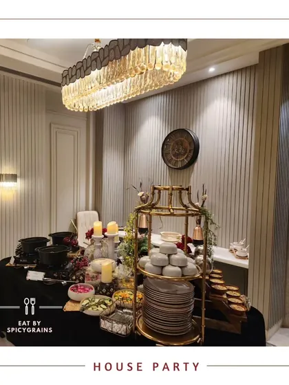 An elegant and intimate house party setup. The buffet is neatly arranged under a stunning chandelier, showing how we can transform any space for a special occasion.