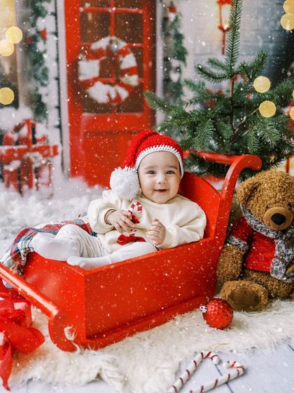 Another angle of this adorable baby in a red sleigh. Her sweet expression is priceless.