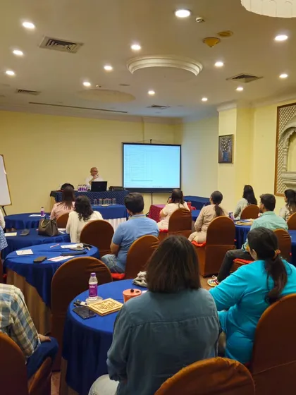 A wide view of the workshop hall, showing the setup and the engaged audience.