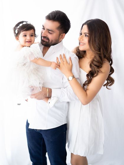 A bright and happy family portrait in classic white outfits.
