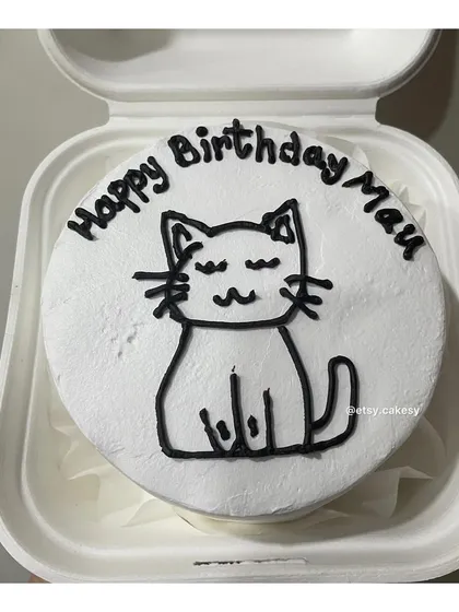 A minimalist birthday bento cake for a cat lover, featuring a simple line drawing of a cat and a wish for 'Mau'.