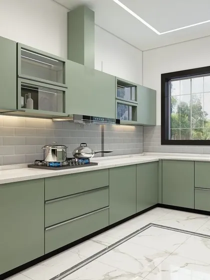 This kitchen showcases a fresh, modern aesthetic with sage green cabinetry and a white subway tile backsplash. The design includes a mix of solid and glass-front upper cabinets, a built-in chimney, and under-cabinet lighting for a bright and practical workspace.