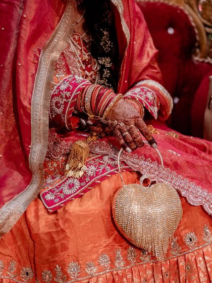 A detail shot of the bride's stunning heart-shaped clutch and the intricate embroidery on her lehenga. I believe these small details are a big part of the story.