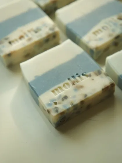 The blue and white layers of this soap are dotted with colorful soap confetti.