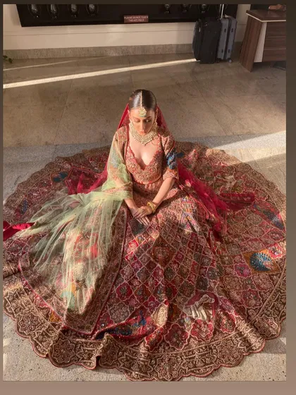 Another perspective of the sun-kissed bride, showcasing the grandeur of her lehenga. The makeup is designed to be long-lasting and picture-perfect, holding up beautifully in any setting.